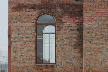 Poster - one large window on a brown wall of a building 