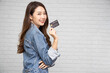 © comzeal - Young beautiful Asian woman smiling, showing, presenting credit card for making payment or paying online business, Pay a merchant or as a cash advance for goods, Cardholder or A person who owns a card