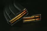 Fototapeta Na sufit - Top view of gun magazines on a black surface background. Rifle. M4. 5,56x45