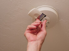 Replacing Battery In Home Ceiling Smoke Detector Fire Alarm.