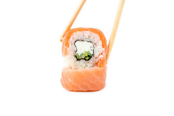 take philadelphia maki rolls with bamboo chopstick on white background