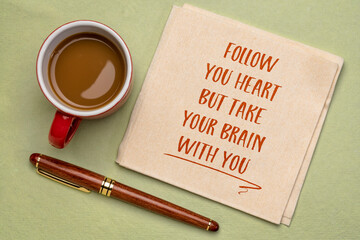 Wall Mural - follow your heart, but take your brain with you  - inspirational handwriting on a napkin with a cup of coffee, personal development and self improvement concept