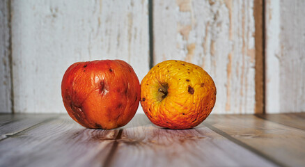 Wall Mural - Apples lit from the sun decoratively lying on a wooden underground.