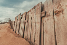 Worn Wooden Fence On Sandy Beach