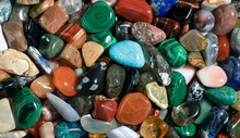 Gemstones Background Image. Various Polished Semi Precious Gemstones Top View. Chakra Healing Stones And Crystals. Turquoise, Amethyst, Quartz, Agate And Many More.