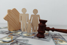Family Figure With Judge Gavel And House On Dollar Banknotes. Family Protection Or Law Concept