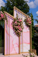 Wall Mural - Sideway view of fashion arch decorated with fresh flowers. Concept of wedding ceremony details.