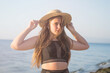 © MartaKlos - Cheerful plus size teenage girl wearing hat enjoying the beach. smiling, happy, positive emotion, summer style.