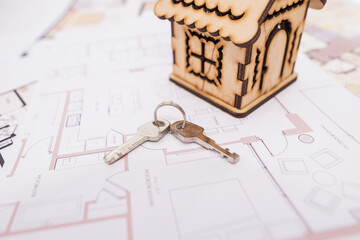 Poster - wooden toy house and keys on the plan of the house.