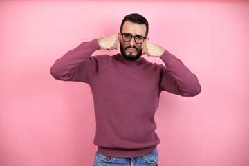 Canvas Print - Handsome man wearing glasses and casual clothes over pink background depressed and worry for distress, crying angry and afraid. Sad expression.