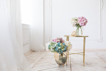 Wall Mural - Tender simple  interior in light colors with tule, bouquets of artificial hydrangea and elegant  mirror table on light parquet floor