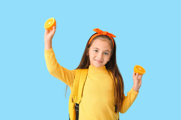 Wall Mural - Cute little girl with orange on color background