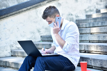 Businessman in medical mask working outdoor