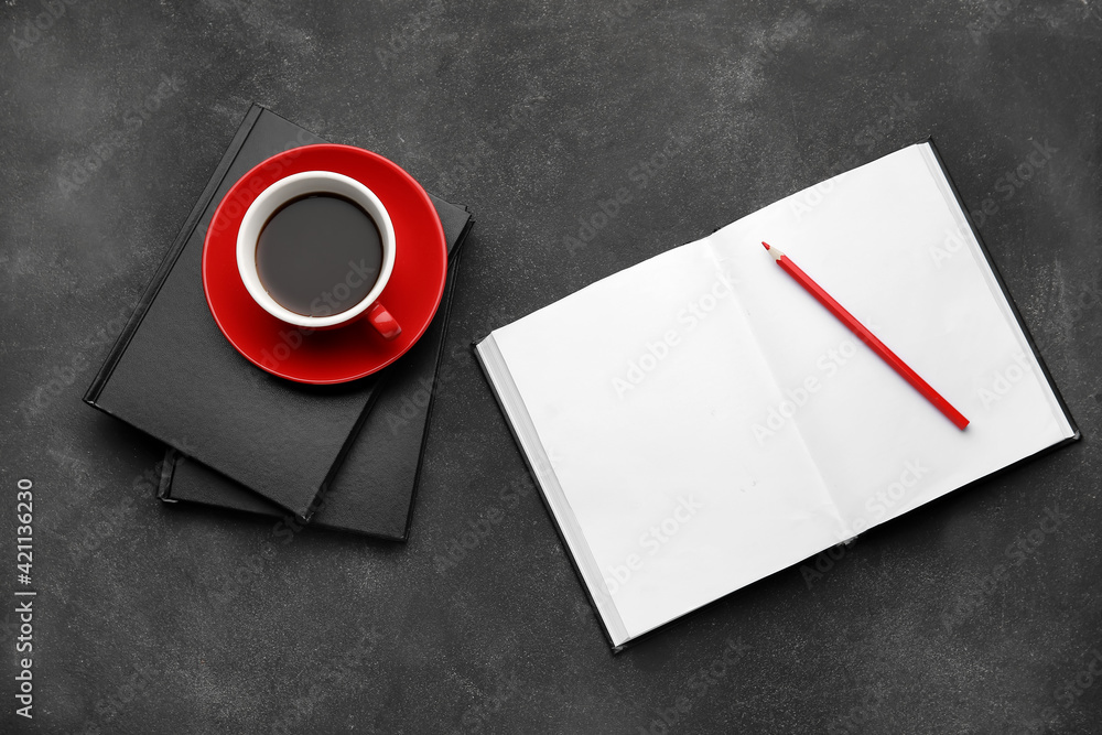 Composition with books, pencil and cup of coffee on dark background