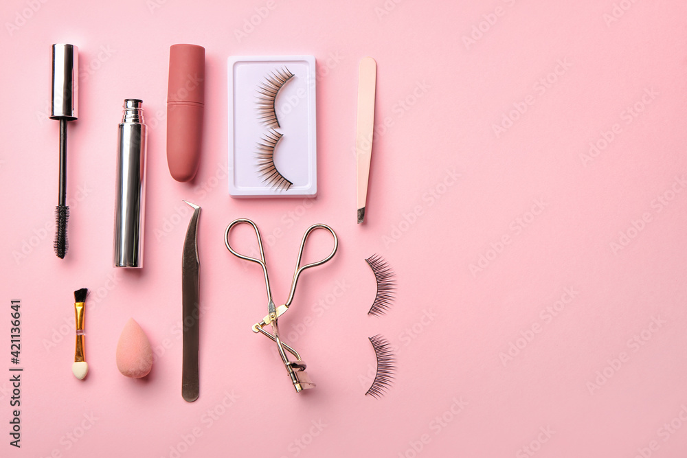 False eyelashes, decorative cosmetic and tools on color background