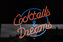 Red And Blue Neon Sign At A Pub Saying Cocktails And Dreams