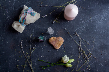 Wall Mural - Magic flat lay composition with pink candle, crystals, pagan bag and flowers. Esoteric and pagan rituals, witchcraft Wiccan or spiritual practice (healing). Ritual for love. Herbal treatment.