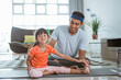 happy father and kid doing sport together. portrait of healthy family and daughter workout stretching at home