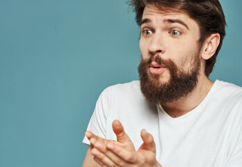 Portrait of a man blue background close-up cropped view white t-shirt handsome smile