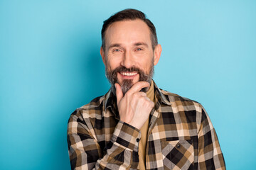 Poster - Photo portrait of aged man thoughtful smiling touching chin isolated on bright blue color background