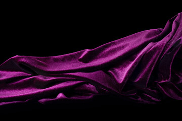 Purple velvet fabric folds on black background.