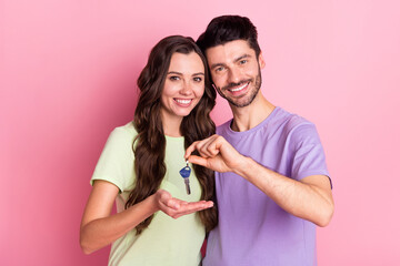 Canvas Print - Portrait of attractive cheerful couple embracing holding in hand key home credit loan invest isolated on pink pastel color background