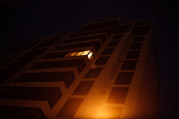 Sticker - the light burns in one window of the multitude in a multi-storey residential building