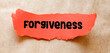 FORGIVENESS written on a small red piece of paper.