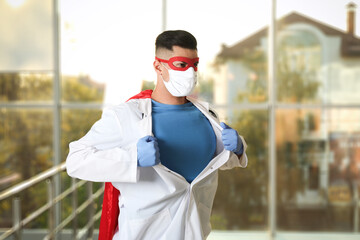 Canvas Print - Doctor wearing face mask indoors. Super hero power for medicine