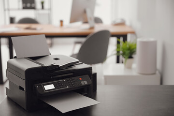 New modern printer on table in office. Space for text