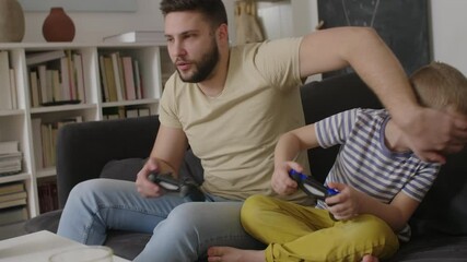 Wall Mural - father playing video games with his son at home	