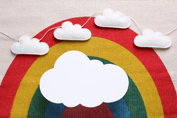 Canvas Print - Cloud shaped child's night lamp on fabric with rainbow pattern, flat lay