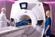 © Roman - Medical technical assistant performing radiological scan of patient with magnetic resonance tomography MRI