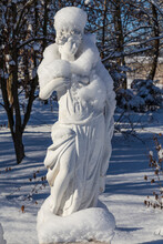 Snow Covered White Statue In The City Park