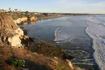 California Coast, Pismo Beach, From a Cliff with the Sun Low Showing the Powerful Waves Eroding the Rock Shore as the Waves Erode the Rock