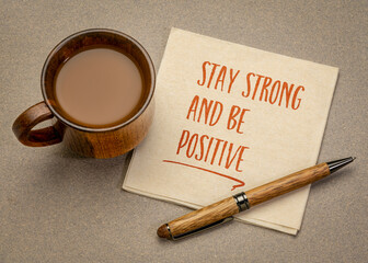 Wall Mural - stay strong and be positive  inspirational handwriting on a napkin with a cup of coffee, positivity and personal development concept