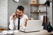 © JustLife - Young businessman talking to the phone. Businessman in office using the phone.