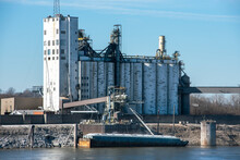 Grain Elevator Terminal Spout Loading Grain Corn Into Bulk Dry Cargo Barge On Mississippi River, Food, Crops, Harvest, Export, Transport, Marine, Maritime, Silos, Storage Containers