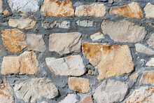 The Texture Of The Wall Is Made Of Rough Stone.