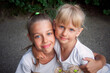 Portrait of two blue-eyed girls. sisterhood of friendship concept. smiling children embrace outdoor. childhood happines.