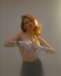 © Georgii - Redhead young beautiful naked girl wearing white gloves cover her breast, studio portrait of sensual ginger female
