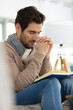 © auremar - young man praying on wooden bible at home