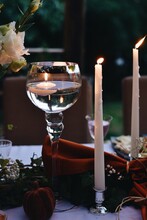 Close-up Of Lit Candles On Table