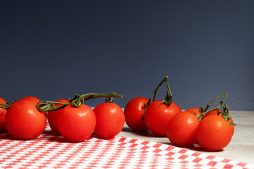 Delicious red tomatoes on the blue background.