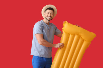 Sticker - Handsome man with inflatable mattress on color background