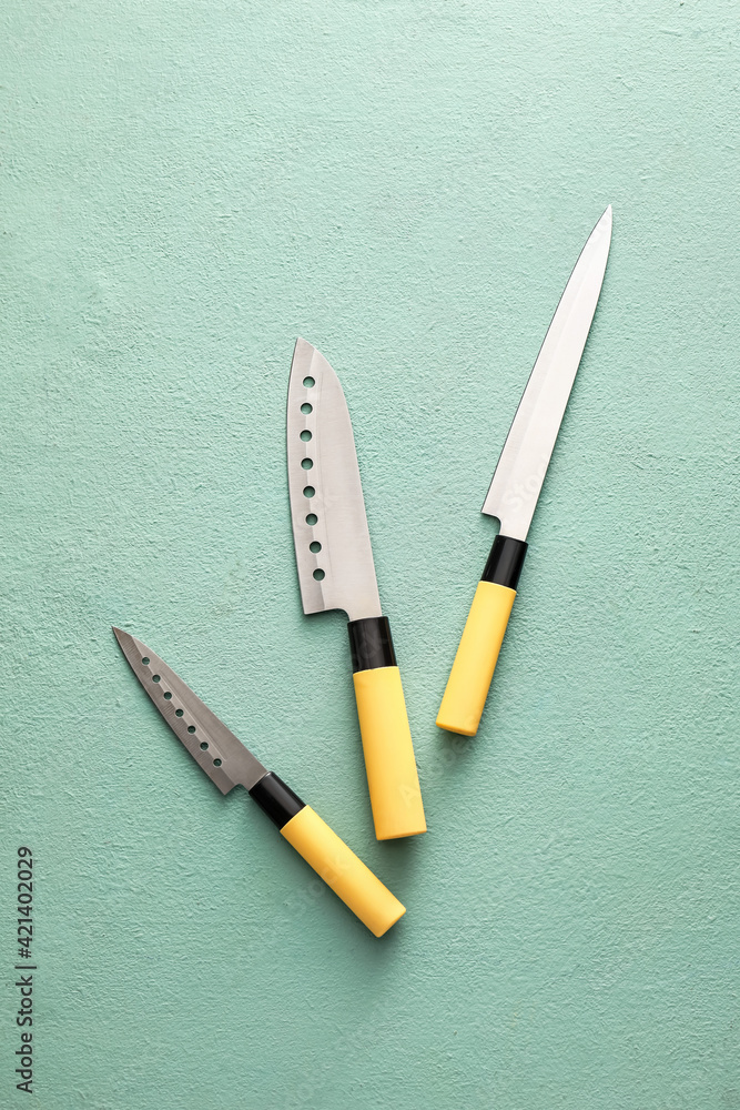 Set of knives on color background