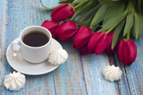 Fototapeta Tulipany - bouquet of red tulips, cup of coffee, meringue on blue wooden background