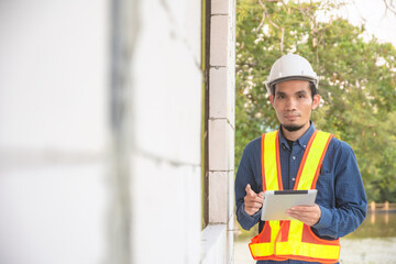 Foreman checking house in construction site by tablet technology