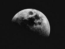 Low Angle View Of Half Moon Against Sky At Night