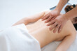 © dikushin - Top close-up view of male masseur massaging back and shoulder blades of female lying on massage table at spa salon. Beautiful young woman with perfect skin getting relaxing massage.